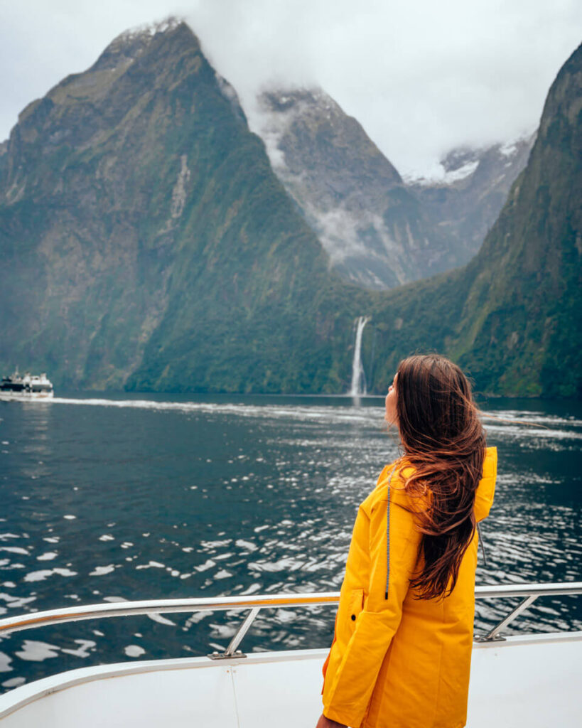 Travellers planning a New Zealand road trip on a map