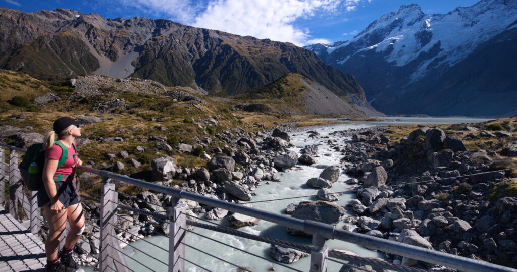 Hikers walking through a New Zealand alpine landscape