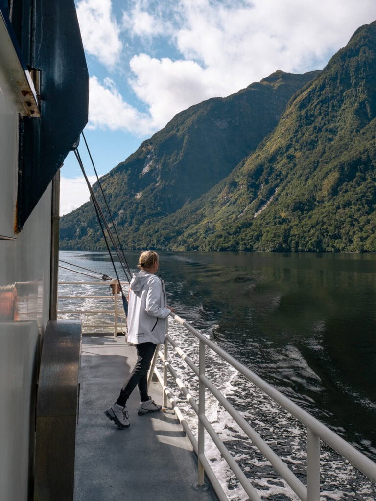 Rental car travelling along a scenic New Zealand road